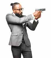 Free photo man in suit pointing with a gun