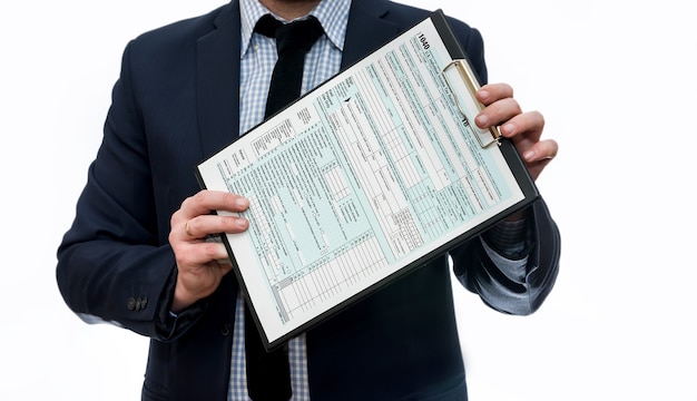 Man in suit showing 1040 tax form on clipboard isolated on white