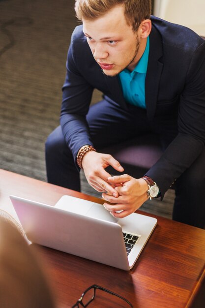 Man in suit sitting at table