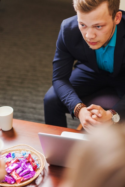 Man in suit sitting at table