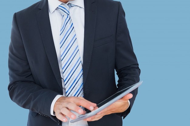 Man in suit and tie with a tablet