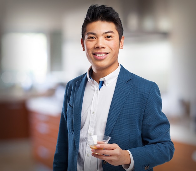 Man in suit with a drink in his hand