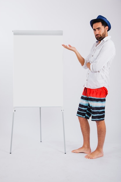 Man in summer wear next to canvas