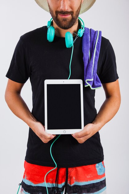 Man in summer wear holding tablet close up view