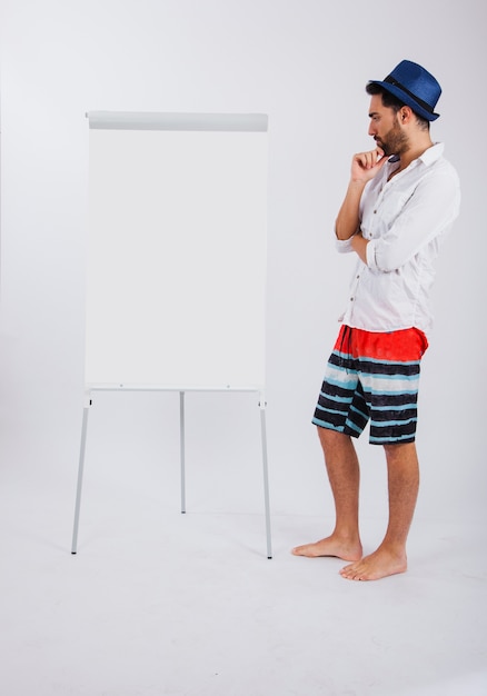 Man in summer wear looking at canvas