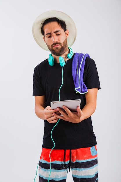 Man in summer wear looking at tablet