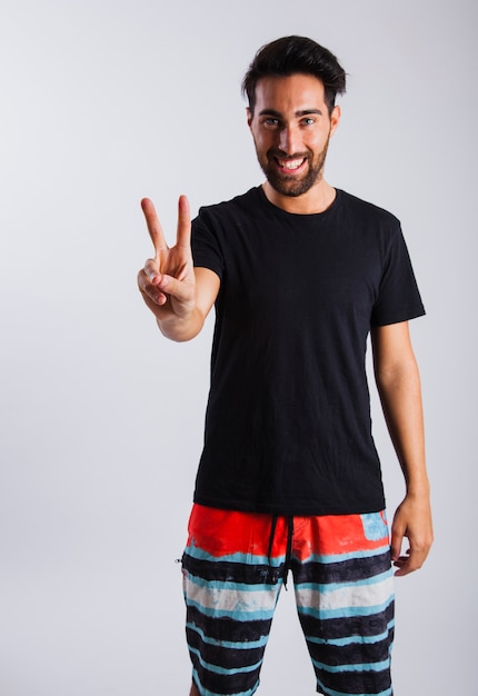 Man in summer wear making peace sign