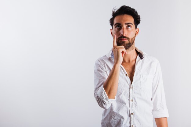 Man in summer wear pointing upwards