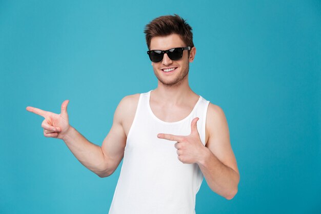 Man in sunglasses pointing isolated