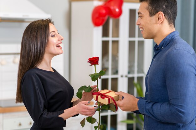 Man surprising his girlfriend with a valentine's day gift