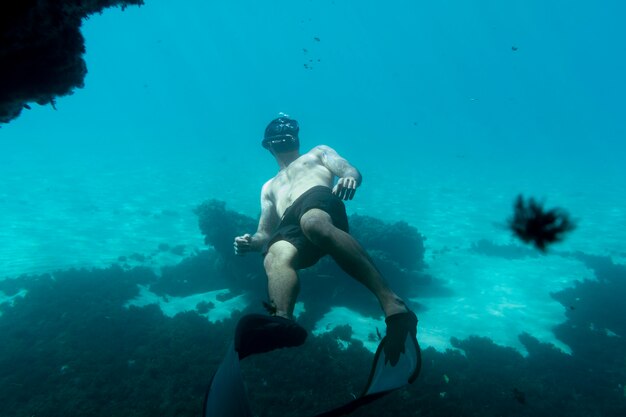 Man swimming under the ocean