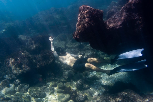 Foto gratuita uomo che nuota sott'acqua