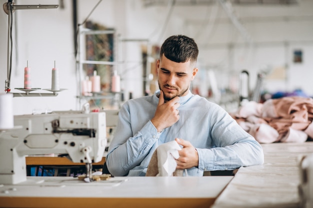 Man tailor working at a sewing factory