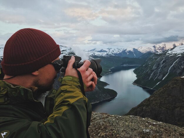 Man takes a picture of gorgeous Scandinavian landscape