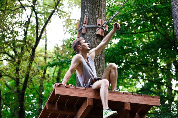 Man takes selfie sitting on the tree