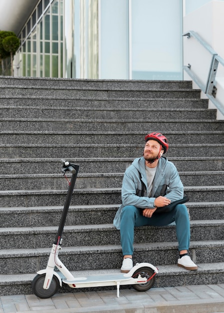 Man taking a break after riding his scooter