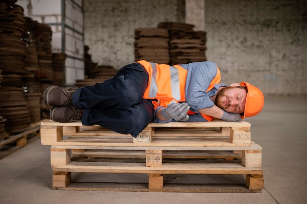 Free photo man taking a break from work and sleeping