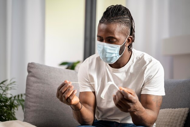 Man taking a covid test alone at home