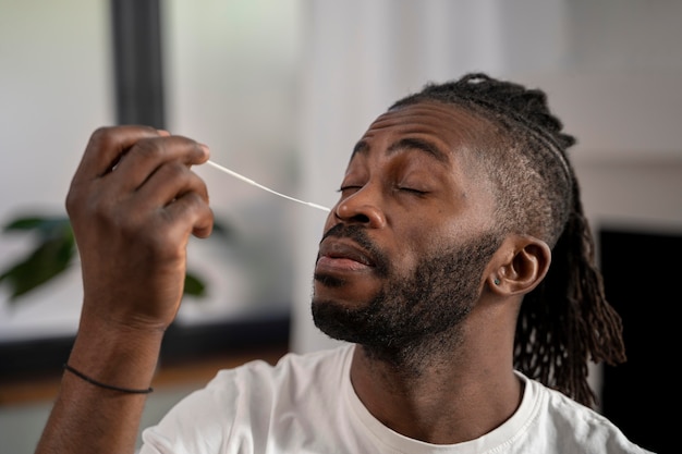 Man taking a covid test alone at home