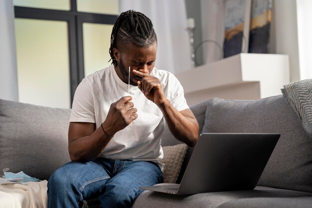 Man taking a covid test alone at home