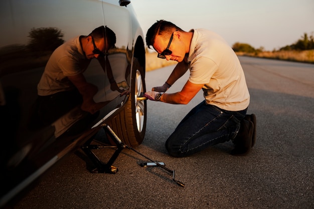 Man taking off the car wheel