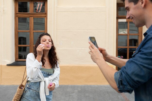 Man taking a photo of his cute girlfriend