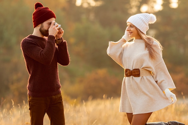 Man taking a photo of his friend while posing