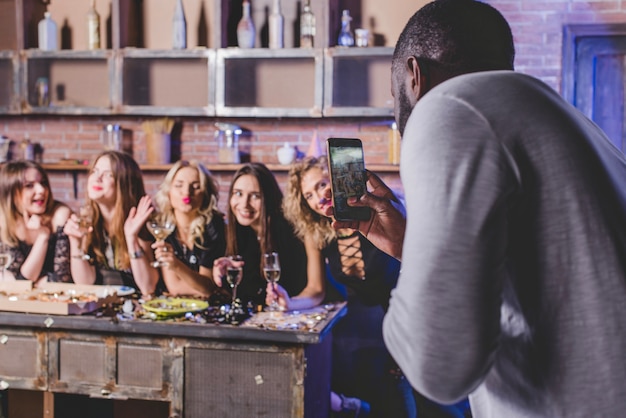 Man taking shots of festive women