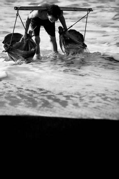 Man taking water from the sea