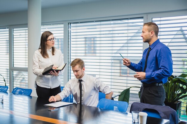 Man talking to coworkers in office