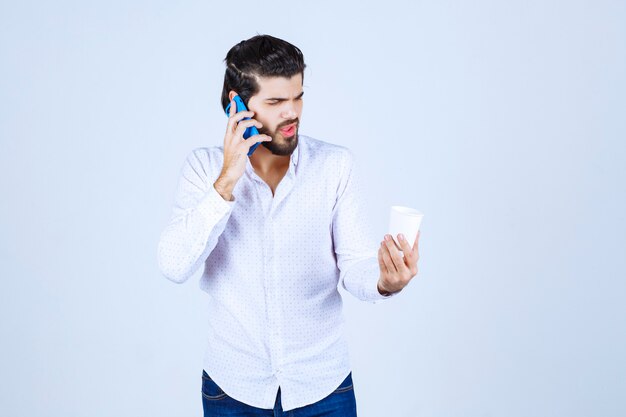 Man talking to his blue new model smartphone