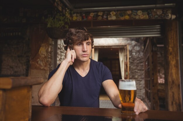 Man talking on mobile phone in bar