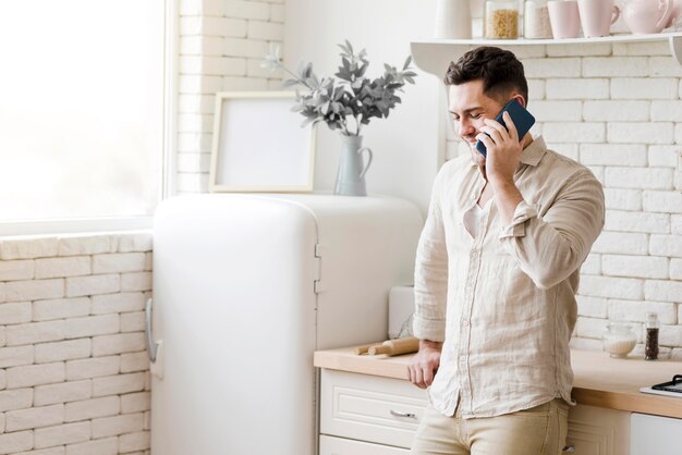 Man talking on the phone in kitchen