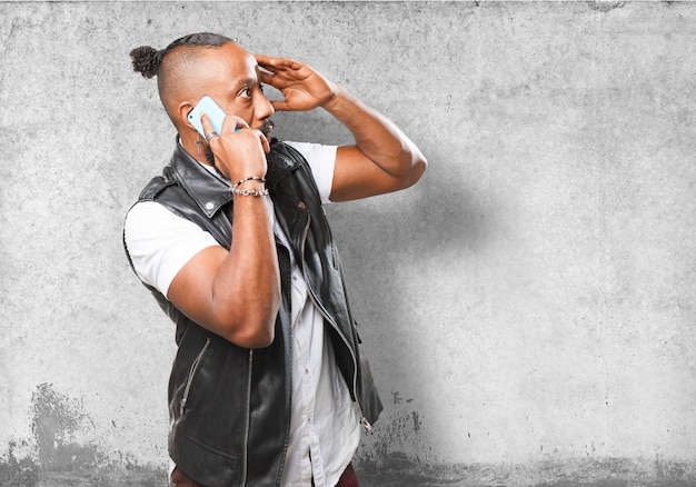 Man talking on the phone with a hand on the forehead