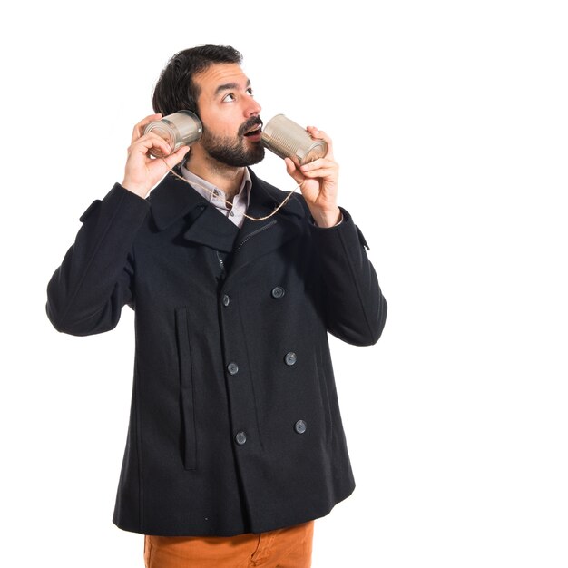 Man talking through a tin phone