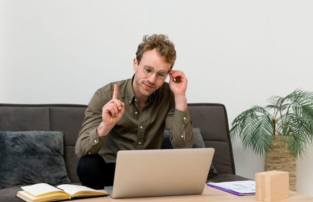 Man talking with his coworkers in an online meeting