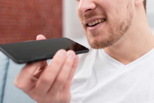 Man talking with his phone assistant close-up