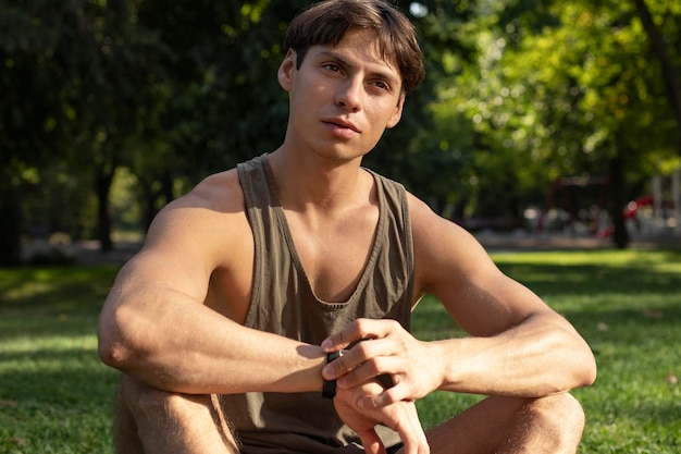 Free photo man in tank top working out in nature