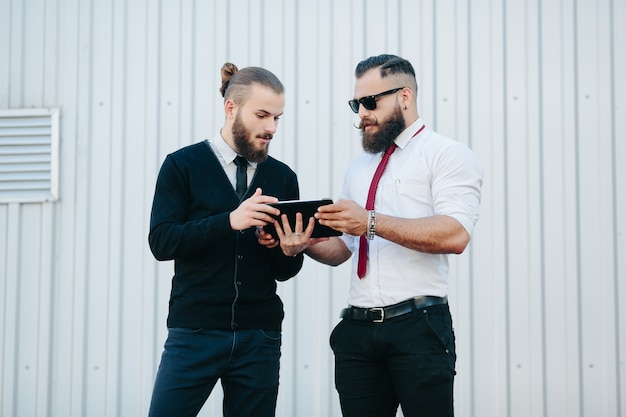 Man teaching another a tablet