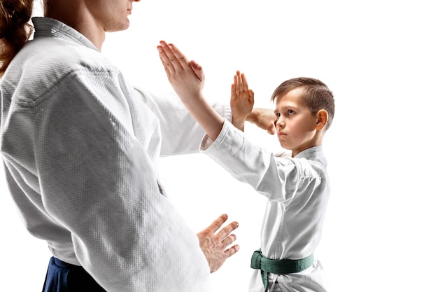 Free photo man and teen boy fighting at aikido training in martial arts school. healthy lifestyle and sports concept.