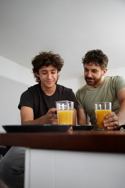 Man and teen with juice front view