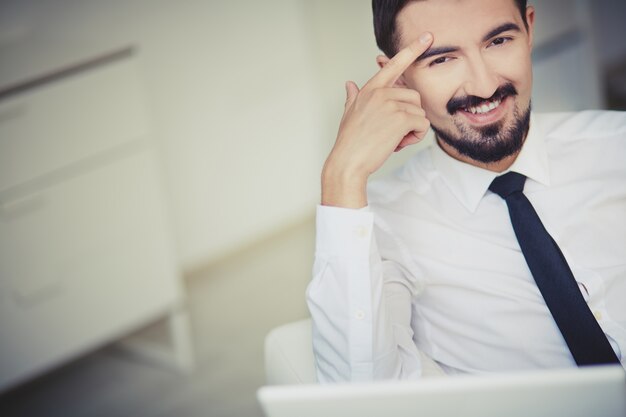 Man thinking with finger on forehead