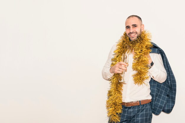 Man in tinsel with champagne glass 