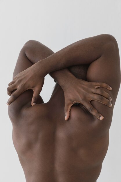 Man touching his back with his hands