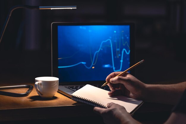 man trading browsing online stock investments at night