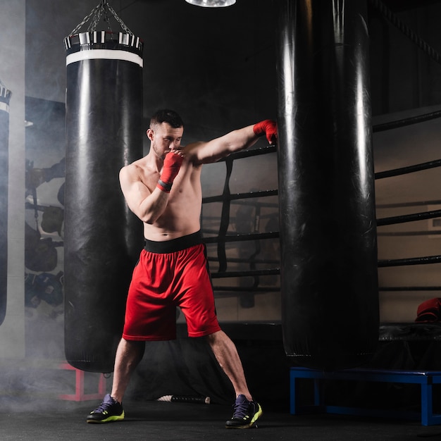 Free photo man training for boxing competition