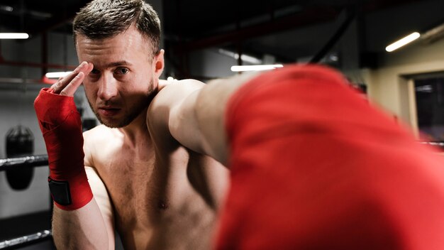 Man training in boxing ring close-up