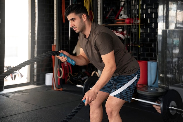 Man training at gym side view