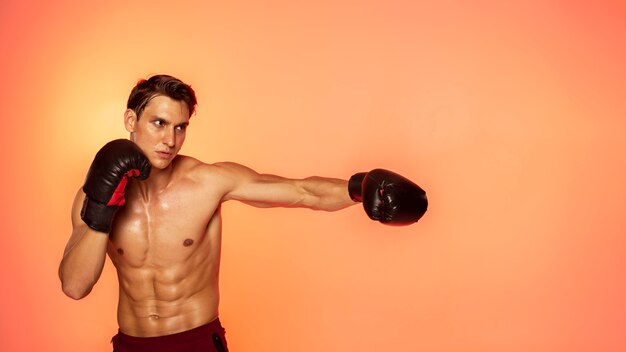 Man training with boxing gloves medium shot