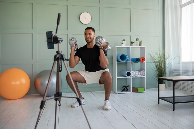 Man training with dumbbells full shot